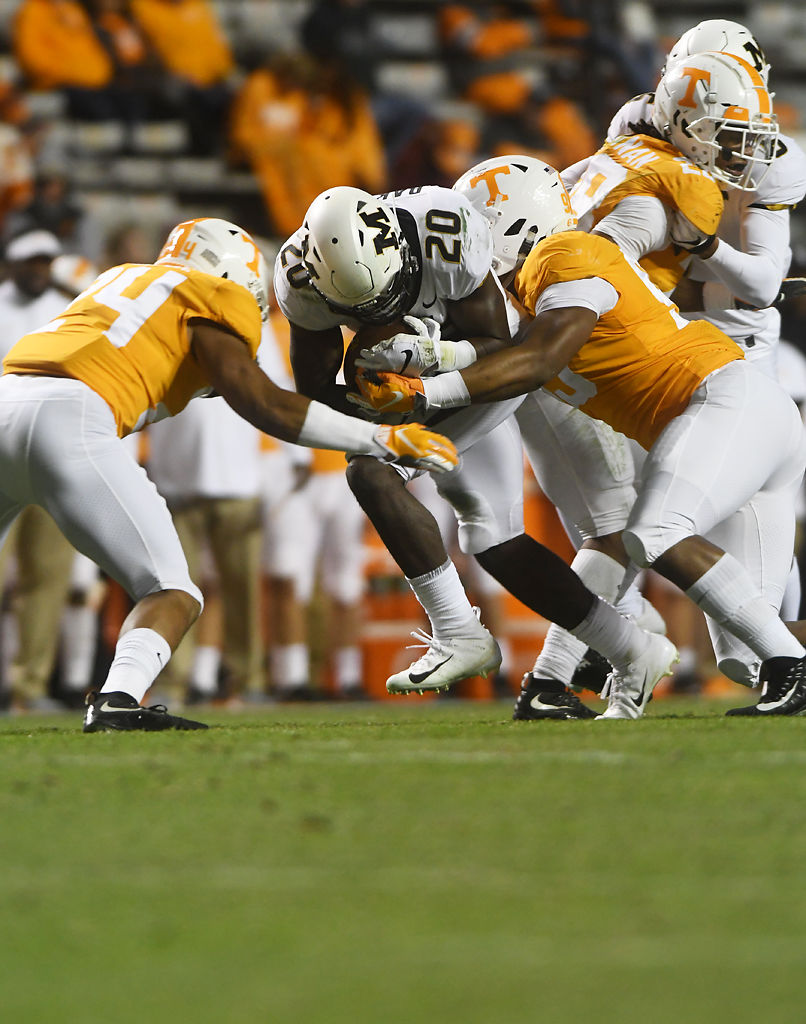 Missouri running back Simi Bakare pushes through Tennessee defenders